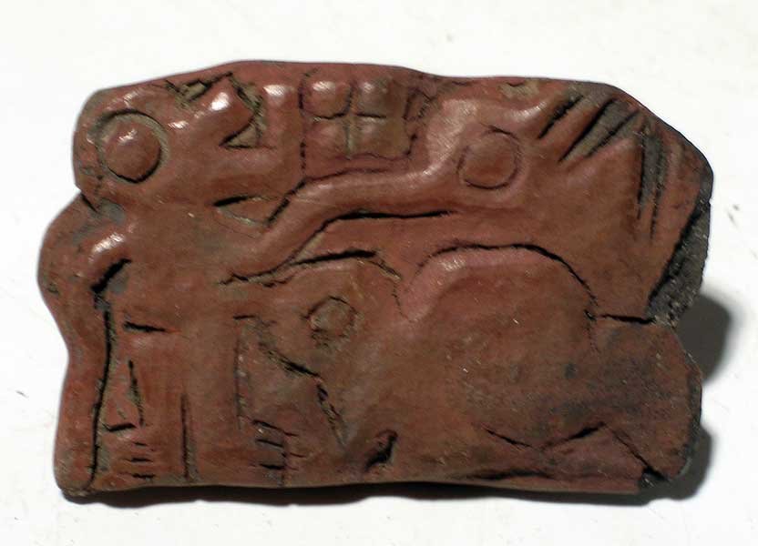 A choice Guangala stamp seal from Ecuador: A choice Guangala stamp seal from Ecuador, ca. 400 BC - AD 400. This burnished red-ware example is 2-1/4 in wide and depicts a trio of conjoined mythological creatures. Ex Murray collection. Rare type