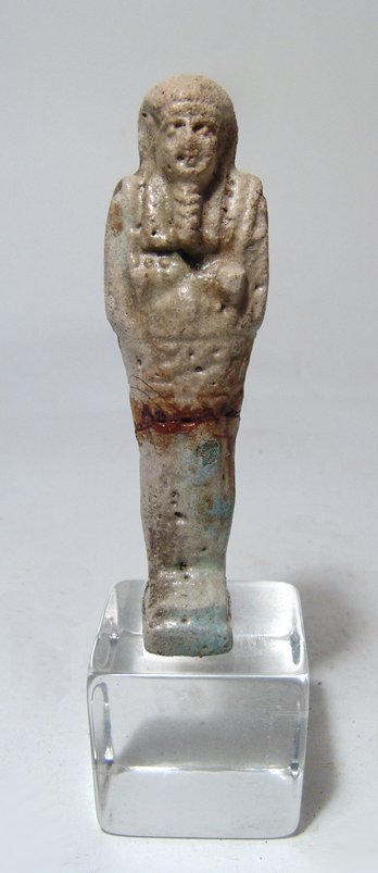 Egyptian pale blue faience ushabti, Late Period: An Egyptian pale blue faience ushabti, Late Period, c. 664 - 332 BC, mummiform, wearing tripartite wig and false beard, arms folded across chest, hands holding a pick and hoe, bag over left shoulder,