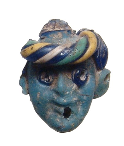 A Phoenician multicolored glass face bead (1 of 4)