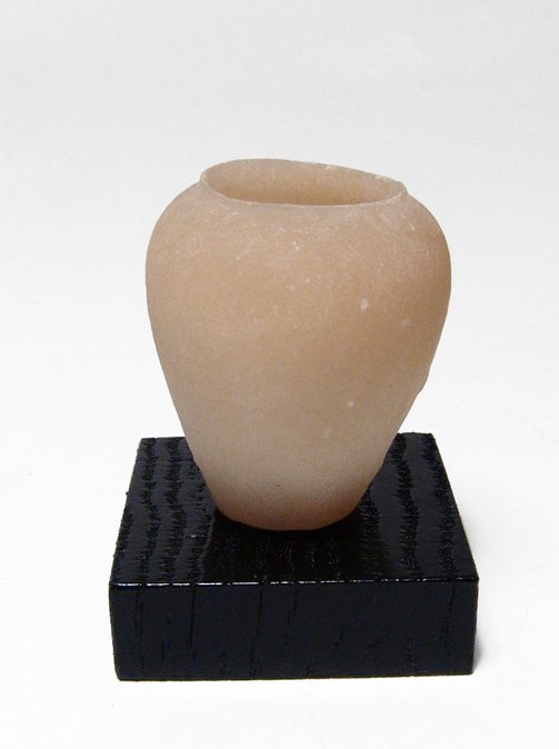 An Egyptian alabaster cosmetic jar, New Kingdom: An Egyptian alabaster cosmetic jar, New Kingdom, c. 1570 - 1075 BC, the body with high shoulders and short vertical rim, the lower part tapered with flat bottom. The interior is well hollowed followin