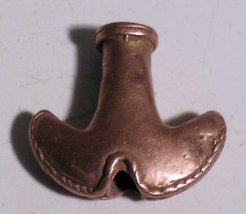 A choice Tairona ornament from Colombia: A choice Tairona ornament from Colombia, ca. 1000 – 1500 AD. This finely detailed pendant is ¾ in long and is made from gold. Ex Cobb estate.