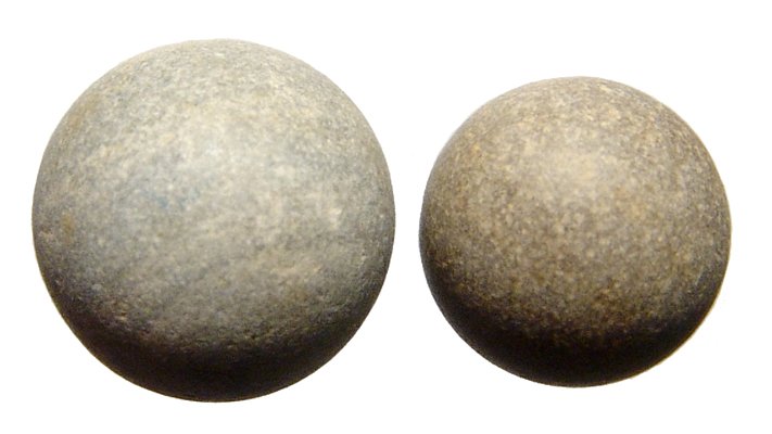A pair of Tudor stone marbles, England: A pair of Tudor stone marbles, England, c. 16th Century, found in the River Thames. Each is in superb condition. Dia: 12mm to 15mm. Ex Los Angeles private collection.