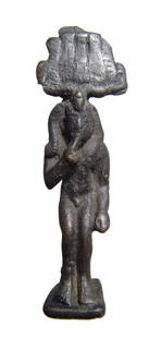 An Egyptian bronze figure of Harpokrates: An Egyptian bronze figure of Harpokrates, Late Period, c. 664 - 332 BC, depicted nude, wearing triple uraei headdress and side-lock, right finger pressed to his lips. His feet rest on a flat integral