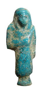 Egyptian blue faience Reis or Overseer Ushabti: An Egyptian blue faience Reis or Overseer Ushabti, 3rd Intermediate Period, 21st Dynasty, c. 1075 - 945 BC, wearing characteristic kilt and rectangular apron of everyday life, tripartite wig with