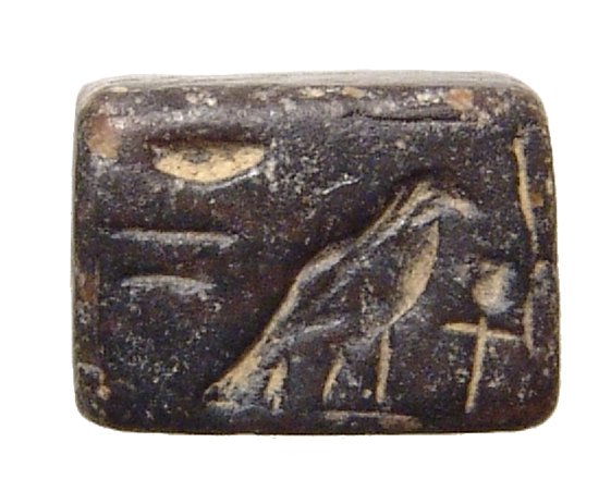 Egyptian steatite plaque with fish and falcon: An Egyptian steatite plaque with fish and falcon, New Kingdom, c. 1570 - 1075 BC, rectangular in shape and rather thick, one side features a Nile perch with a 'nefer' sign above, the opposite side wit