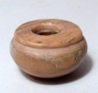 An Egyptian alabaster cosmetic vessel