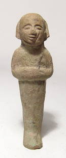 An interesting Egyptian bi-color faience ushabti: An interesting Egyptian bi-color faience ushabti, 3rd Intermediate Period, c. 1075 - 664 BC, mummiform, with short wig, arms folded across chest, hands holding a pick and hoe. The face is very well