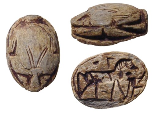 An Egyptian steatite scarab depicting a horse: An Egyptian steatite scarab depicting a horse, New Kingdom, c. 1570 – 1075 BC, the body nicely carved with lines giving the look of a hare from above. On the base, a horse standing rt., a man before