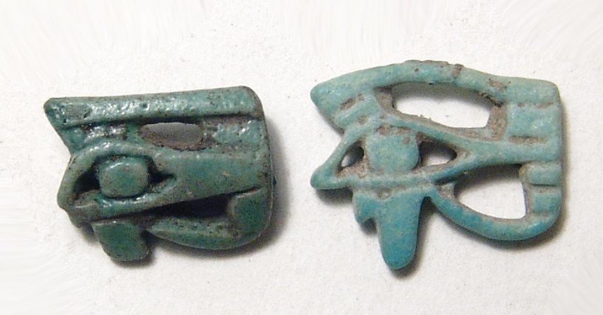 A pair faience Eye of Horus amulets: A pair faience Eye of Horus amulets, 3rd Intermediate Period, c. 1075 – 664 BC, the first with pleasant openwork design and pale green color. (18x14m), the other open work with deeper green color. (