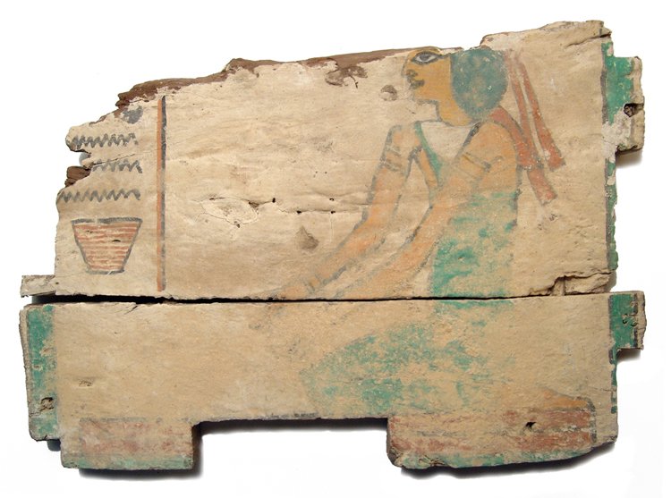 Egyptian wood ushabti box panel, Late Period: An Egyptian wood ushabti box panel, Late Period, c. 664 - 32 BC, depicting a kneeling woman wearing a tight-fitted gown, head band with long ties and jewelry, her features nicely rendered and her hand