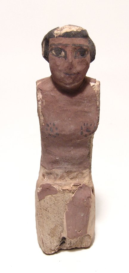 Egyptian wooden figure, Middle Kingdom: An Egyptian wooden figure, Middle Kingdom, c. 2061 – 1690 BC, from a model boat, the male figure is kneeling, wearing a short kilt and wig, well-preserved with much of the original pigments preserve
