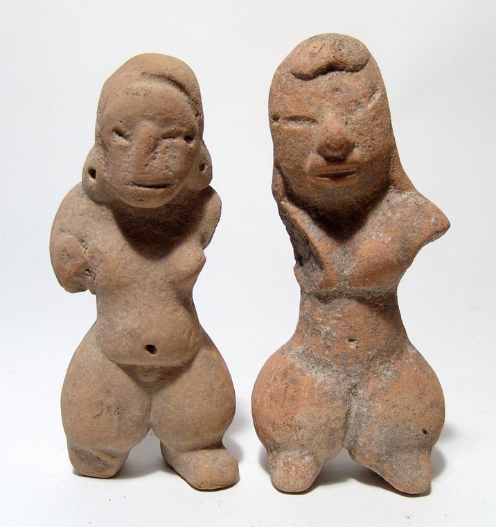 A pair of Pre-Classic figures from Mexico: A pair of Pre-Classic figures from Mexico, c. 1200 – 900 BC, perhaps Tlapacoya, both female with nicely modeled faces and shorts ovoid legs. H: 5 in (12.8 cm) and 5 3/8 in (13.7 cm). Heavy mineral d