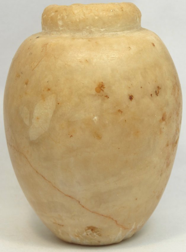 Attractive Egyptian alabaster cosmetic kohl ja: A very attractive Egyptian alabaster cosmetic kohl jar, Late Period, c. 664-343 BC, with an inverted rim and an oval shaped body, H: 3 in (7.8cm). Ex collection of a well-known, titled English family 