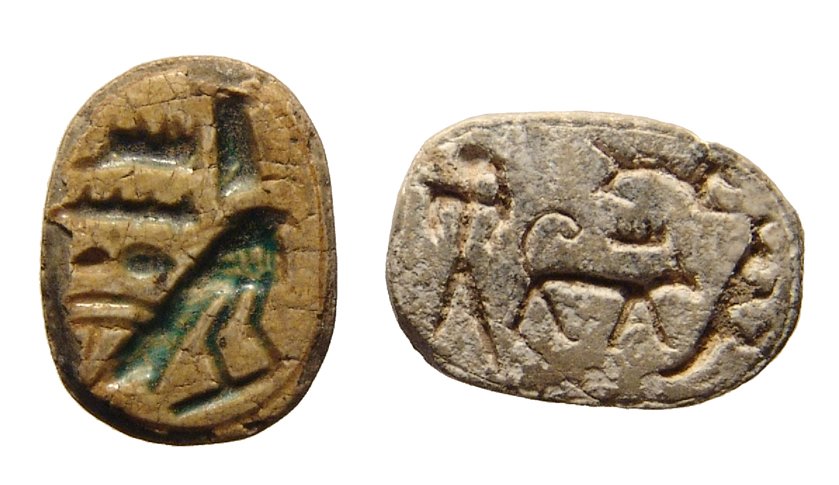 A pair of Egyptian steatite scarabs: A pair of Egyptian steatite scarabs. The first Late Period type, c. 664 - 332 BC, with remnants of green glaze and Horus standing with protection of Amen-Re behind, 17 x 12mm, the second is a 2nd Inte
