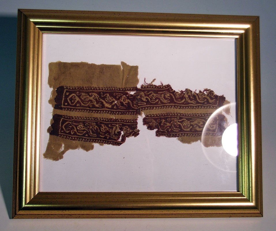 Framed embroidered fragment from a Coptic textile, (1 of 2)