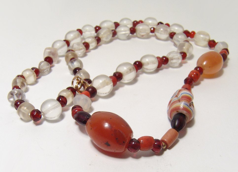 A lovely carnelian and glass bead necklace: A lovely carnelian and glass bead necklace, a mix or modern and ancient stone beads tastefully strung together. L: 25 in (62.9 cm). Nicely re-strung on modern cord and clasp and ready to wear. Ex B.C.