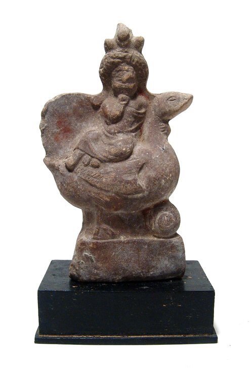 Egyptian terracotta figure of Harpokrates riding a: An Egyptian terracotta figure of Harpokrates riding a swan, Roman Period, c. 1st - 2nd Century AD, the youthful god wears a long tunic, diadem, side lock and a solar headdress, his right finger presse