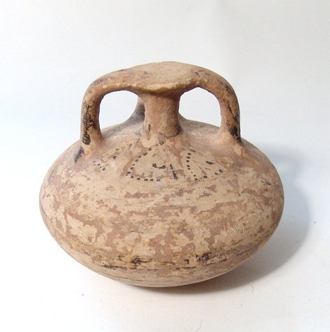 A Mycenaean stirrup vessel, Late Helladic IIIA: A Mycenaean stirrup vessel, Late Helladic IIIA, c. 1400 - 1300 BC, of squat form with traces of concentric bands and geometric designs in black and brown slip. H: 3 ½ in (8.9 cm), w: 4 ¼ in (10.8 cm