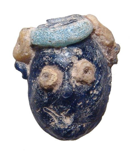 A Phoenician multicolored glass face bead (1 of 3)