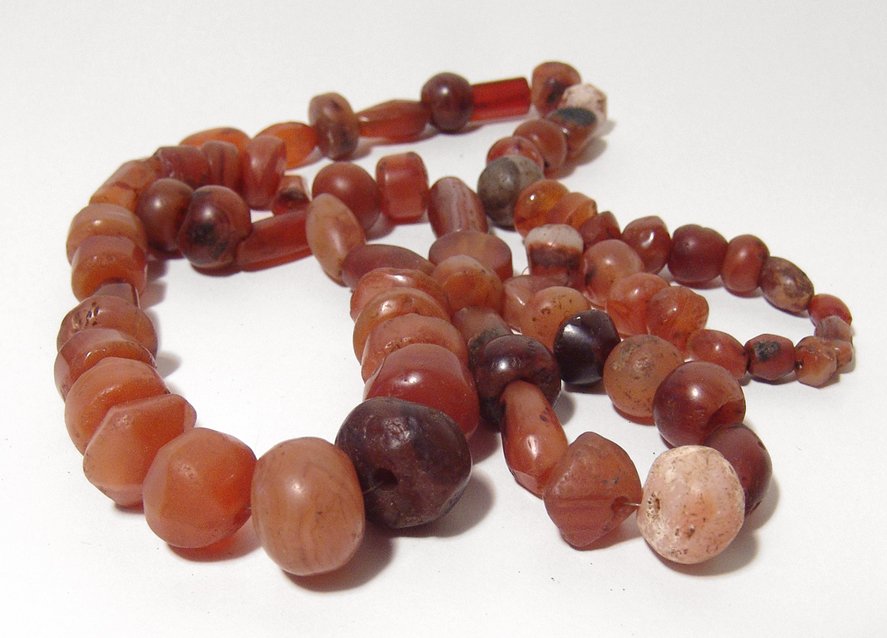 A nice strand of carnelian beads, Holy Land: A nice strand of carnelian beads, Holy Land, c. 1st Millennium BC, most are of a rounded shape and include other of various shapes and sizes, each hand cut and drilled, many retaining their original p