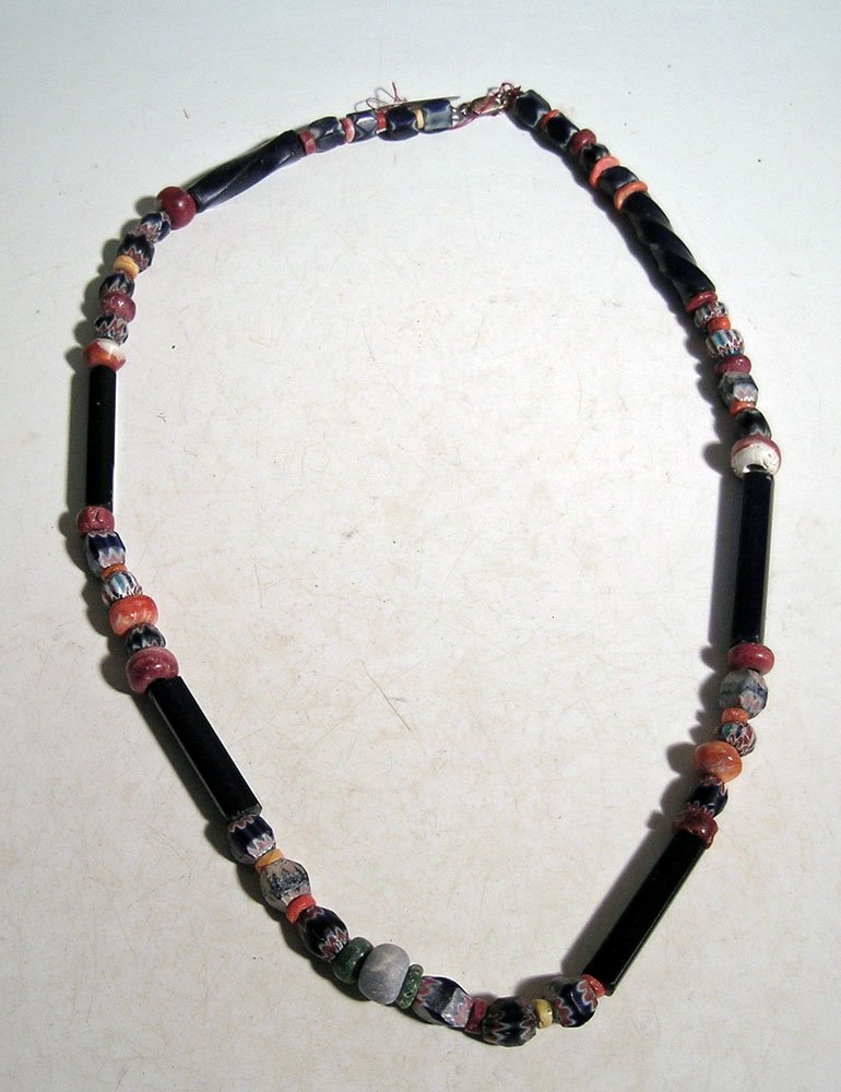 A 23 in long necklace composed of various beads (1 of 2)