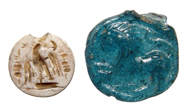 A Roman intaglio and glass pendant with lion, Holy Land: A Roman intaglio and glass pendant with lion, Holy Land, c. 1st – 2nd Century AD, the intaglio round and carved in chalcedony, the face featuring an eagle with open wings standing on a low base, mil