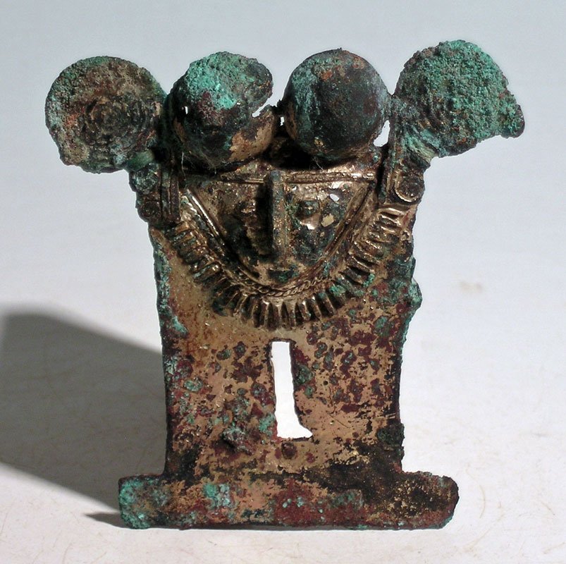Tairona tumbaga pectoral pendant from Northern Colombia: A fine Tairona tumbaga pectoral pendant from Northern Colombia, ca. 1000 – 5000 AD. This rare Darien style example is 2-7/8 in high and depicts a nicely detailed shaman adorned with a necklace and m