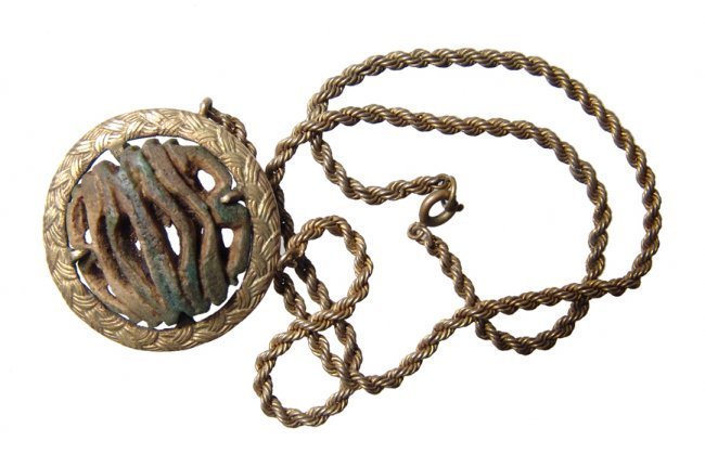 Egyptian faience multiple Eye of Horus pendant: An Egyptian faience multiple Eye of Horus pendant in antique pendant-mount with chain. The amulet, Late Period, c. 664 - 30 BC, is mounted at the center of a brass or very low carat gold setting, 1920
