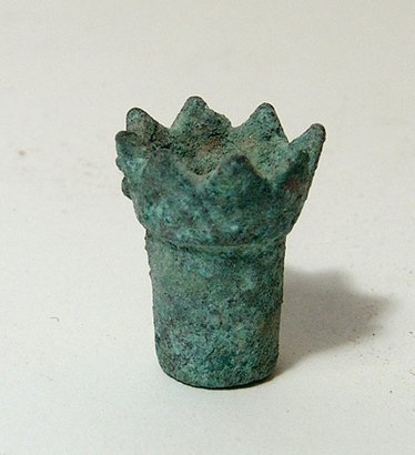 Egyptian bronze incensory in the form of a lotus flower: An Egyptian bronze incensory in the form of a lotus flower, Late Period, c. 664 - 30 BC, the cylindrical body with flattened bottom, hollow interior and spiked petals around the flared rim. 23 x 18mm.