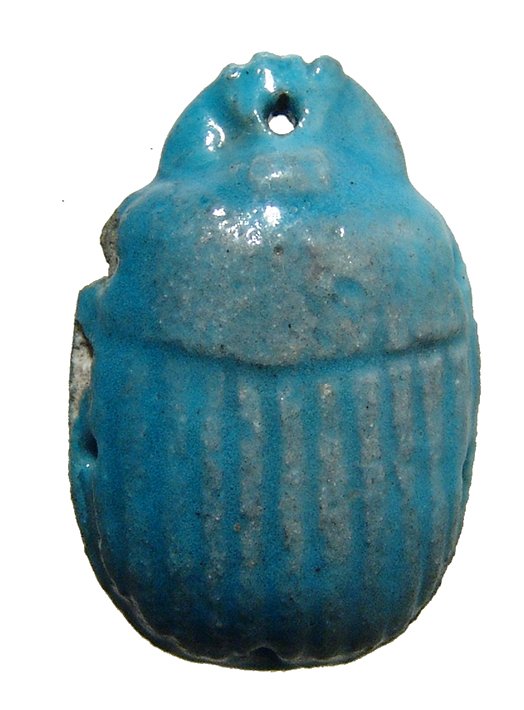 Egyptian turquoise scarab, Ptolemaic Period: An Egyptian turquoise scarab, Ptolemaic Period, c. 3rd - 1st Century BC, from the central portion of a winged scarab pectoral, with holes at the sides to attach the wings. L: 1 2/3 in (4.2cm). Nicely 