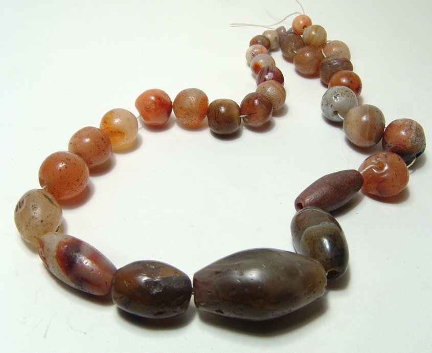 Lovely carnelian and agate beaded necklace: A lovely carnelian and agate beaded necklace, beads from the late Bronze Age, L: 17 3/4 in (45cm). Ex-Ted Seaton collection, founder of the Middleham Jewel.