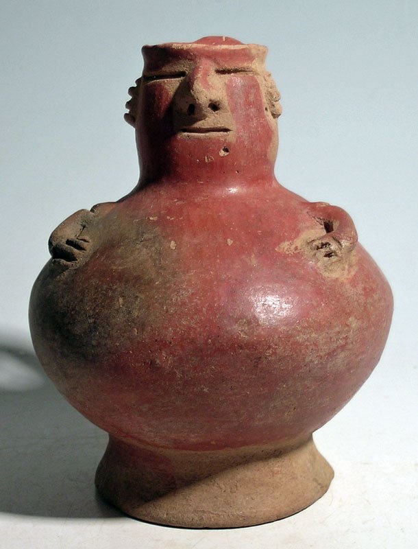 Unusual figural vessel from the Middle Cauca region: An unusual figural vessel from the Middle Cauca region of Colombia, ca. AD 1000 – 1500. This nicely made vessel is 5 in high and has a spout made in the form of a man's head. His arms are appliquéd