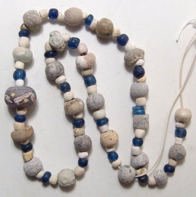 A Near Eastern/Holy Landmixed bead necklace: A Near Eastern/Holy Land necklace consisting of stone and faience beads, mostly 1st to 5th Century AD. L: 10 ¼ in (26.1cm). Ex New York private collection.