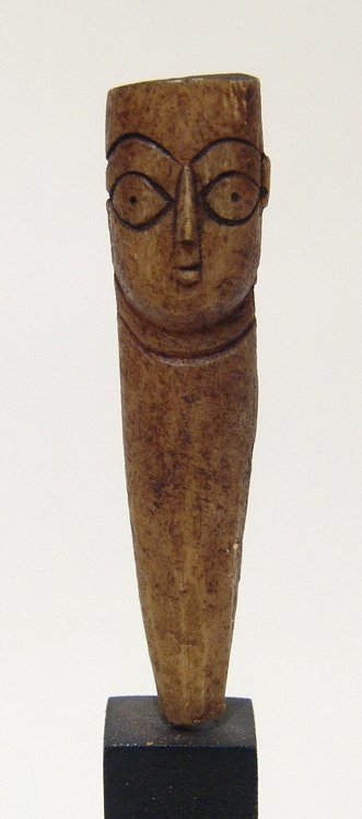A Coptic bone head from a doll, Roman Egypt: A Coptic bone head from a doll, Roman Egypt, c. 5th - 7th Century AD, nicely detailed with large eyes and angular nose, a long wedge or tang at bottom for attachment to the body which would have been 