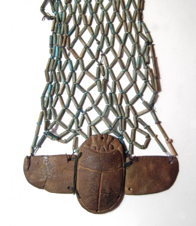 Beautiful Egyptian beaded pectoral net w/ winged scarab: A beautiful Egyptian beaded pectoral net with winged scarab, Late Period, c. 664 - 30 BC, which would have been sewn onto the front of the bandages of a mummy. The scarab and all the beads with varyin