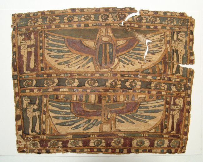 An Egyptian cartonnage panel, Late Period: An Egyptian cartonnage panel, Late Period, c. 664 - 30 BC, depicting a large winged scarab above, a seated winged deity below, each flanked by two mummiform deities (Sons on Horus) and bordered by mul