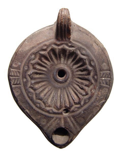 A Roman ceramic lamp with floral pattern (1 of 3)