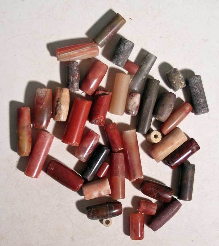 A bag of excellent Tairona stone beads: A bag of excellent Tairona stone beads from Colombia, ca. 1000 - 1500AD. Most are nice tubes made from highly polished carnelian and agate. Great selection of varied sizes. Ex New World Artifacts Gall