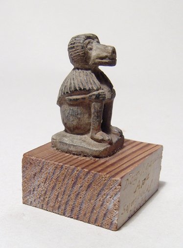 An Egyptian steatite amulet of a seated baboon: An Egyptian steatite amulet of a seated baboon, representative of the god Thoth, 3rd Intermediate Period, c. 1075 - 712 BC, nice carved with good detail, old collection label on front of base. H: 1 1/