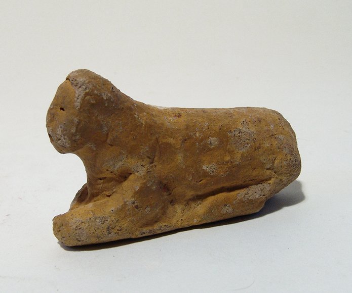 Egyptian stone painted sphinx, Graeco-Roman: An Egyptian stone painted sphinx, Graeco-Roman, c. 2nd Century BC – 2nd Century AD, in classic pose and recumbent on integral base with detailed features and well-preserved golden yellow pigment. L: