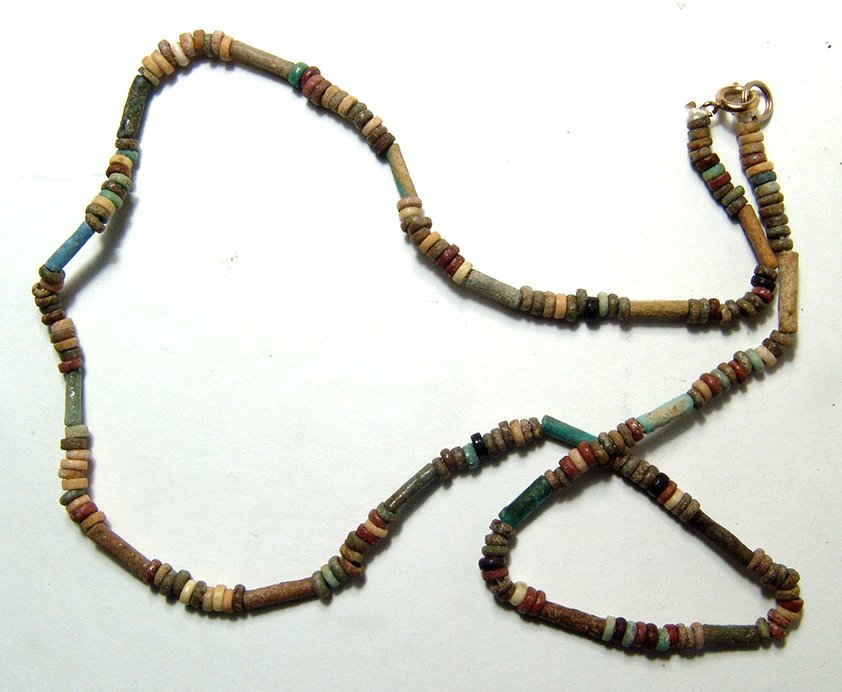 A strand of Egyptian multicolor faience beads: A strand of Egyptian multicolor faience beads, Late Period, c. 664 – 30 BC, of tubular and disk variety, each well-preserved. Length about 18 in (45.6 cm). Ex Time Machine, New York.