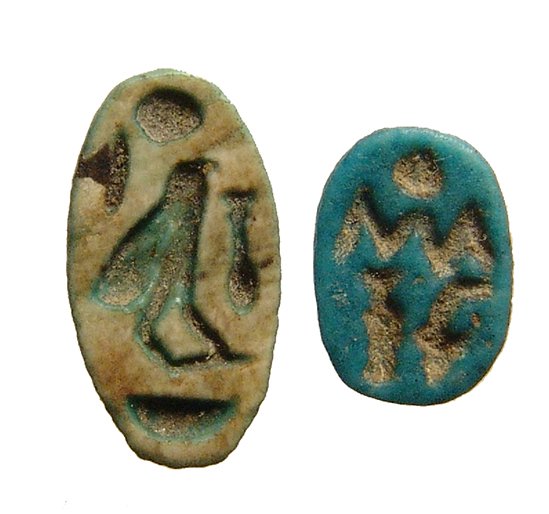 An Egyptian blue faience scarab and a scaraboid: An Egyptian blue faience scarab and a scaraboid, New Kingdom, c. 1570 – 1075 BC, the scarab molded with detailed body and signs for luck and protection on the base, 9 x 7mm, and overall with very ni