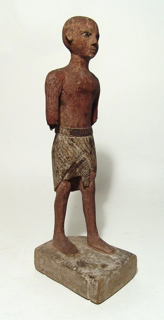 A large Egyptian wooden figure of a man (1 of 8)