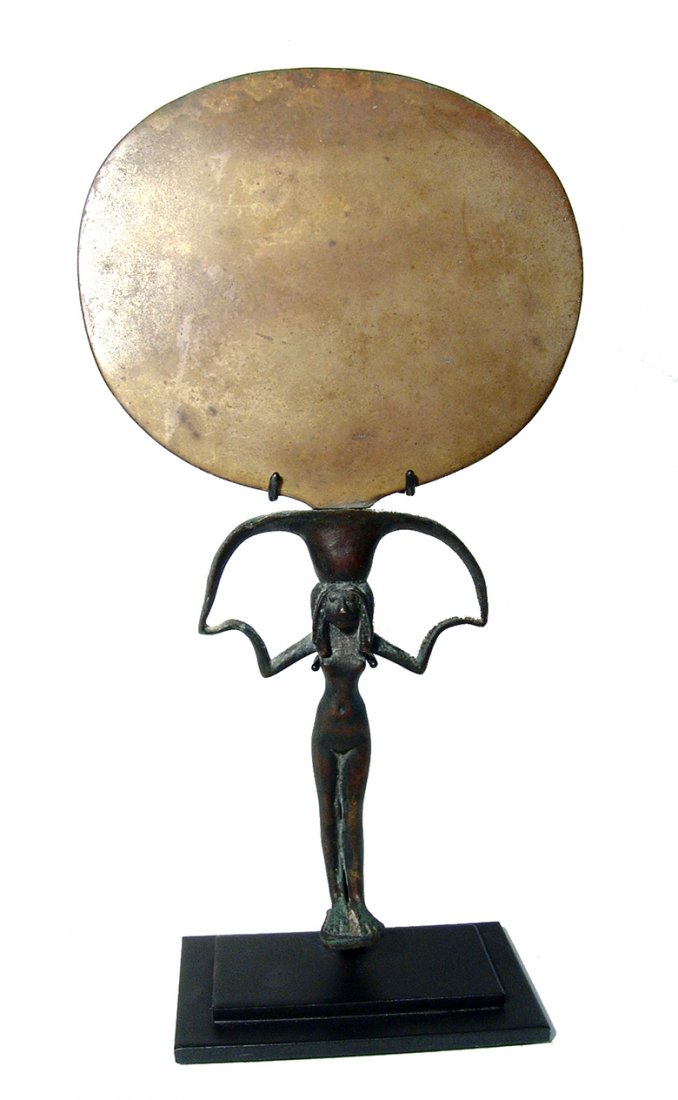A fantastic Egyptian bronze mirror, 18th Dynasty: A fantastic Egyptian bronze mirror, 18th Dynasty, c.1543-1292 BC, the handle in the form of youthful nude woman with her arms supporting the mirror itself, a lovely and typical form that bronze mirror