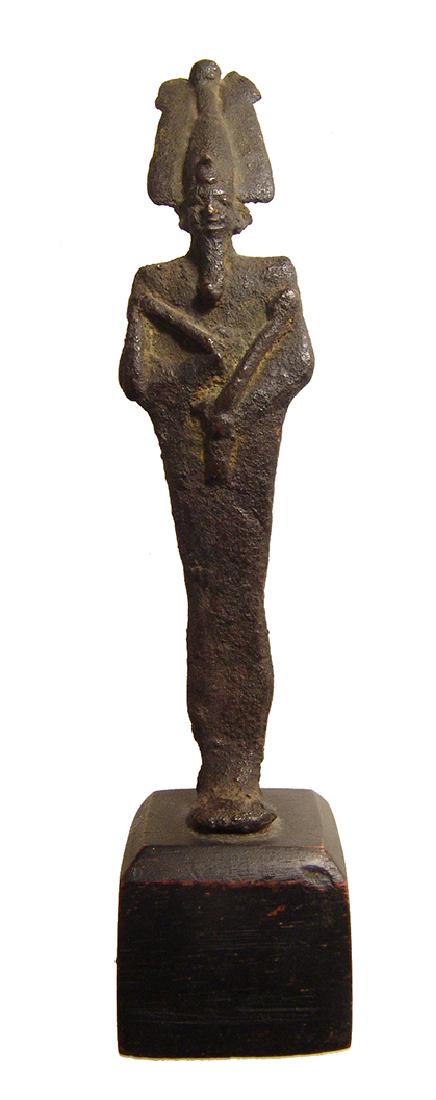 Egyptian bronze figure of Osiris, Late Period: An Egyptian bronze figure of Osiris, Late Period, c. 664 – 332 BC, mummiform, wearing Atef crown with uraeus and false beard, arms folded at chest, hands holding a crook and flail. Nicely detailed w