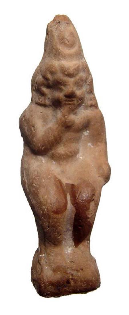 Molded terracotta figure of seated Harpokrates,: A molded terracotta figure of seated Harpokrates, Ptolemaic, c. 2nd - 1st Century BC. The youthful god is without clothing, wearing a headdress consisting of the double crown and a solar disc, right i