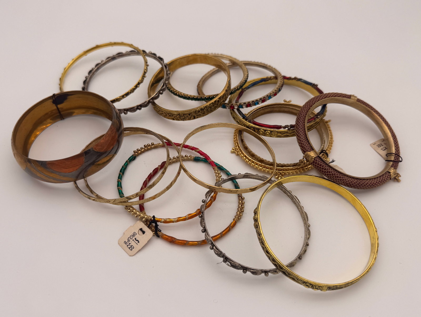 Lot of Vintage Costume Jewelry Bangles, 15+ Pieces: Group of over fifteen assorted vintage costume jewelry bangles in metal, resin, and enamel finishes. Includes decorative etched, beaded, and rhinestone-accented designs, mid-to-late 20th century.