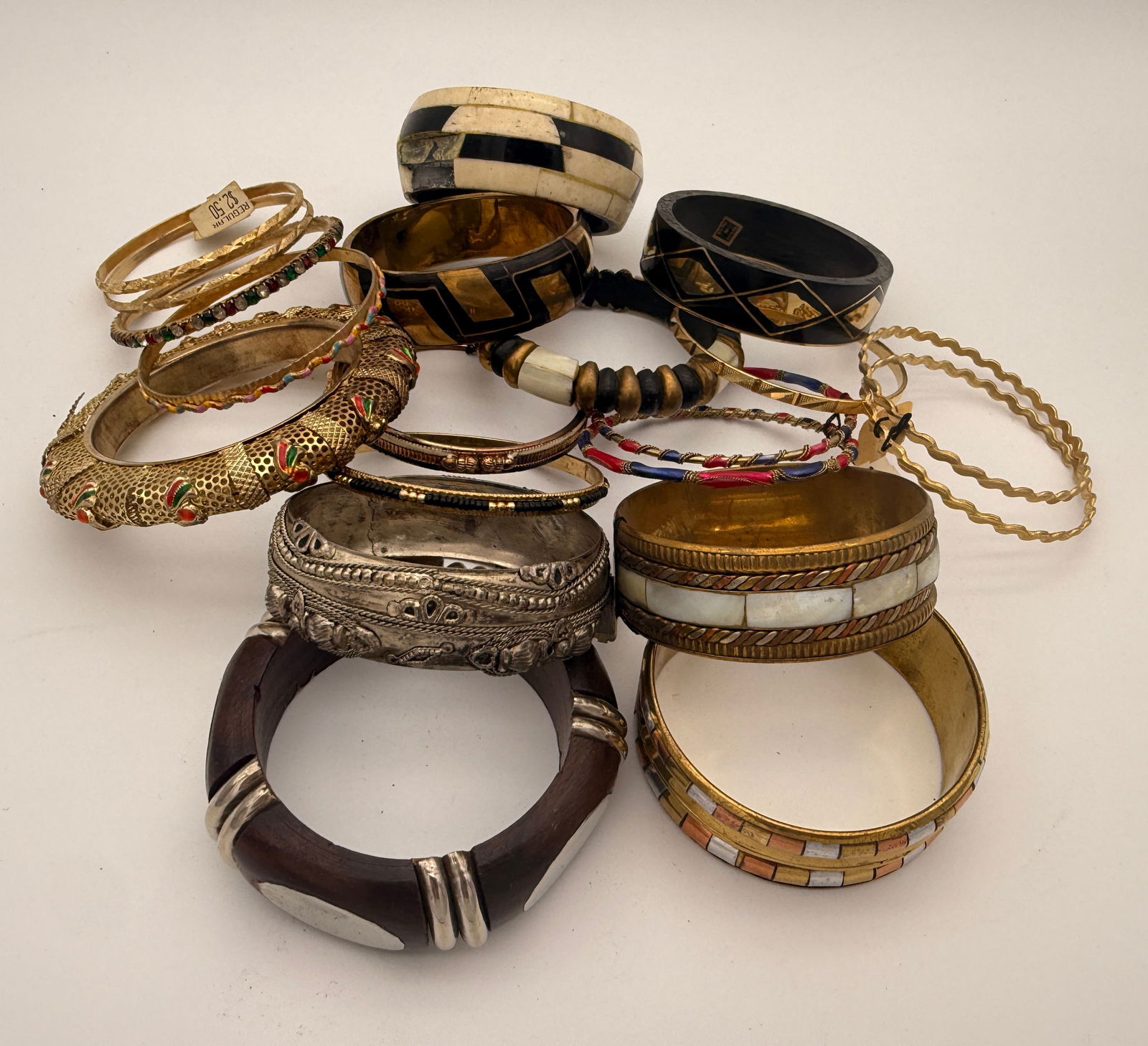 Lot of Vintage Costume Jewelry Bangles, 15+ Pieces: Group of over fifteen assorted vintage costume jewelry bangles in metal, resin, and enamel finishes. Includes decorative etched, beaded, and rhinestone-accented designs, mid-to-late 20th century.