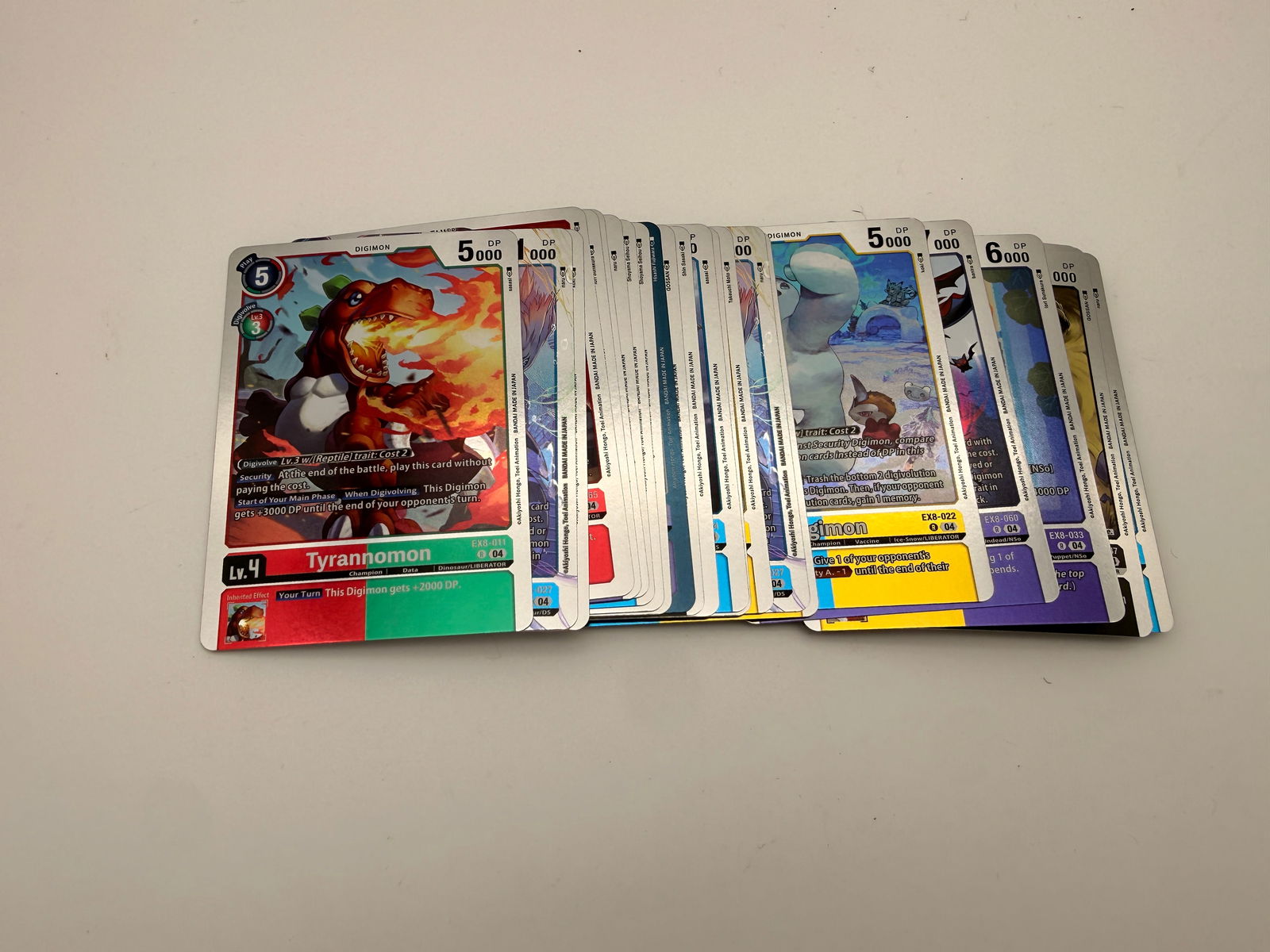 Lot of 30 Holographic Digimon Card Game Cards by Bandai: Collection of thirty holographic Digimon TCG cards from Bandai’s modern 2020+ expansions, including EX and BT series. Each features vibrant foil artwork and collectible numbering.
