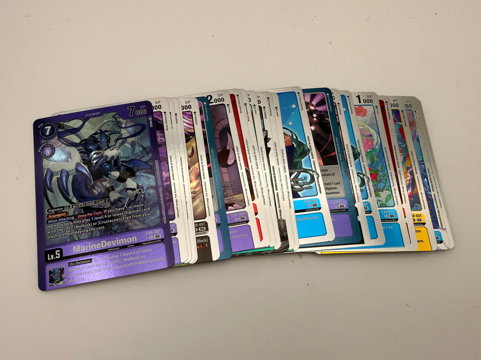Lot of 30 Holographic Digimon Card Game Cards by Bandai: Collection of thirty holographic Digimon TCG cards from Bandai’s modern 2020+ expansions, including EX and BT series. Each features vibrant foil artwork and collectible numbering.